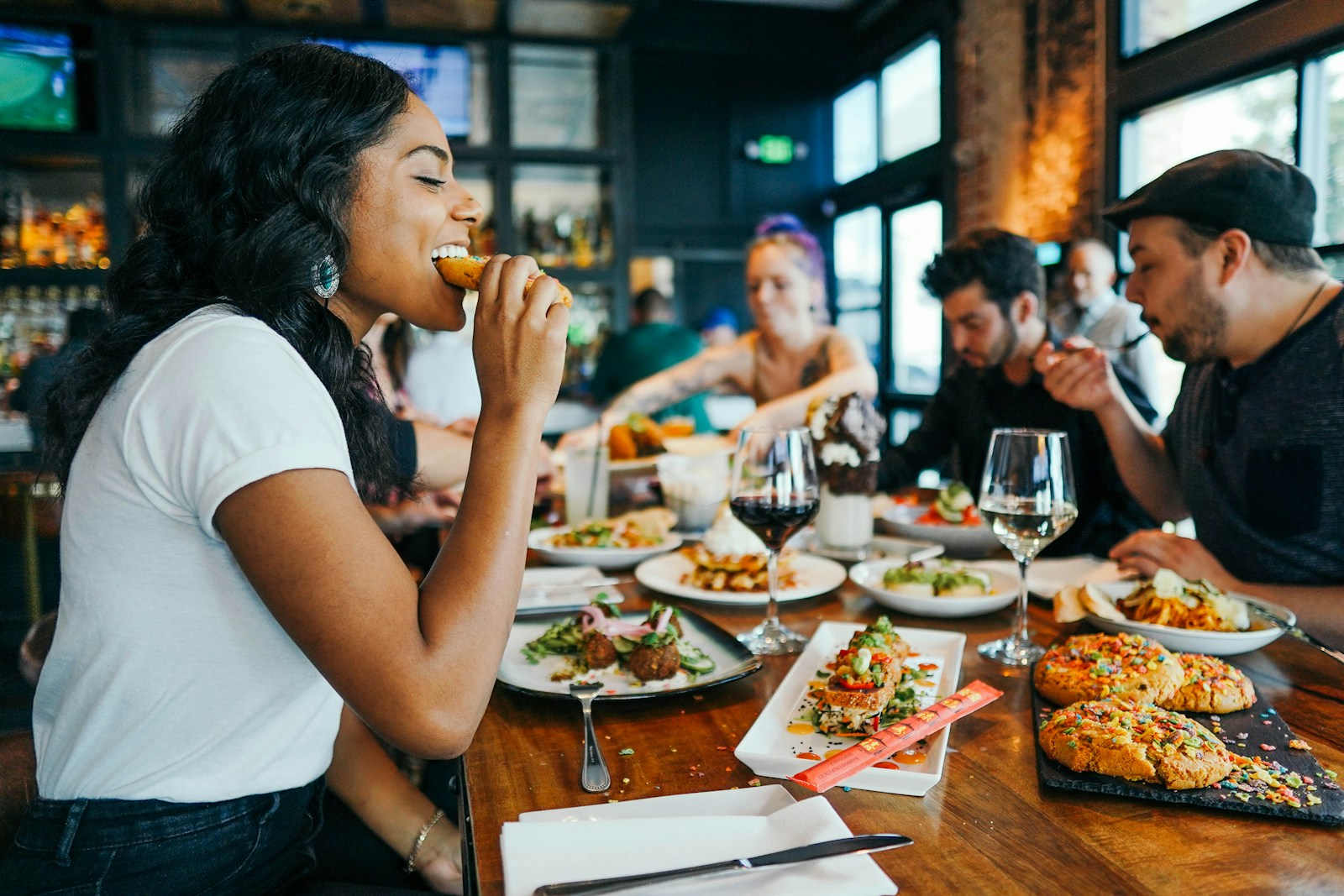 woman in white shirt eating in a place with restaurant insurance